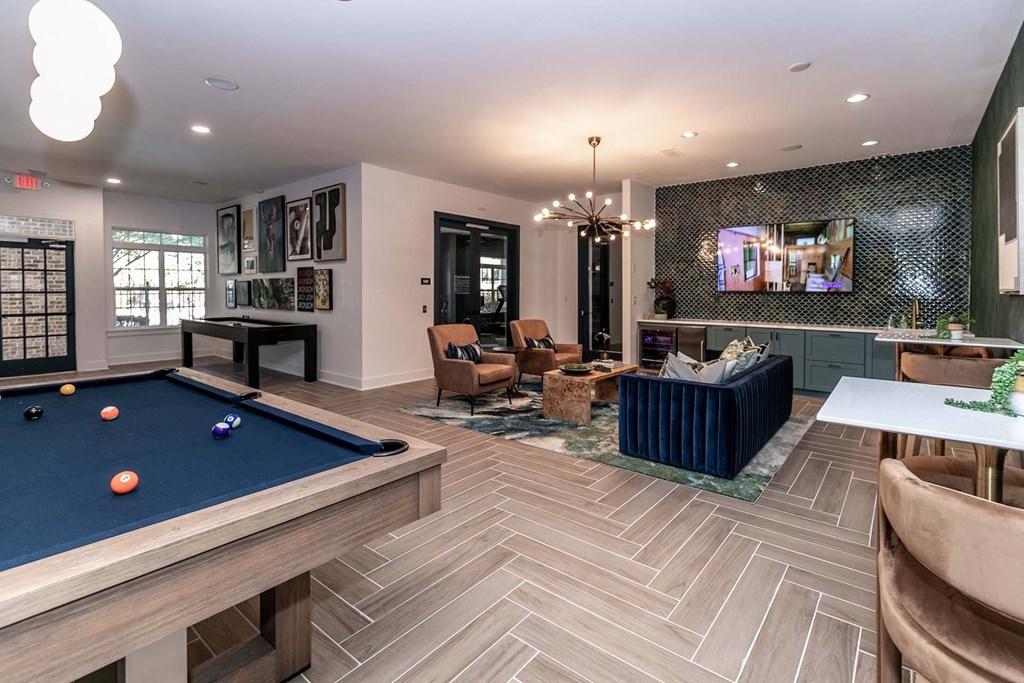 a game room with a pool table and a tv