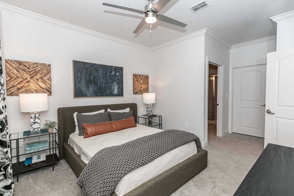 a bedroom with a bed and a ceiling fan