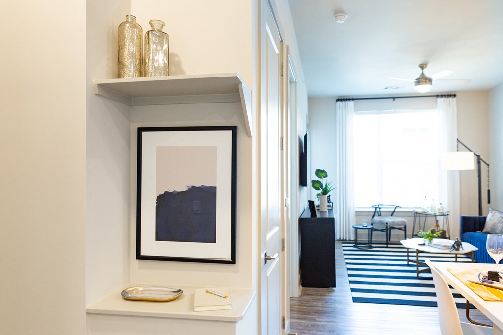 a view of a living room and a hallway with a picture on the wall