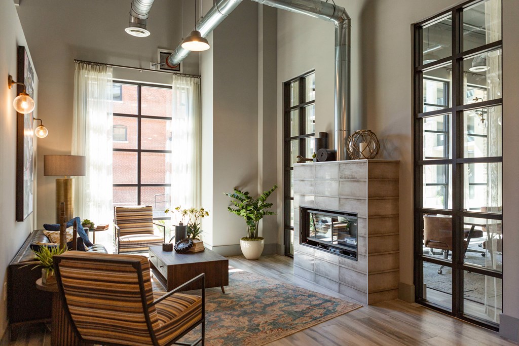 a living room with a fireplace and a large window