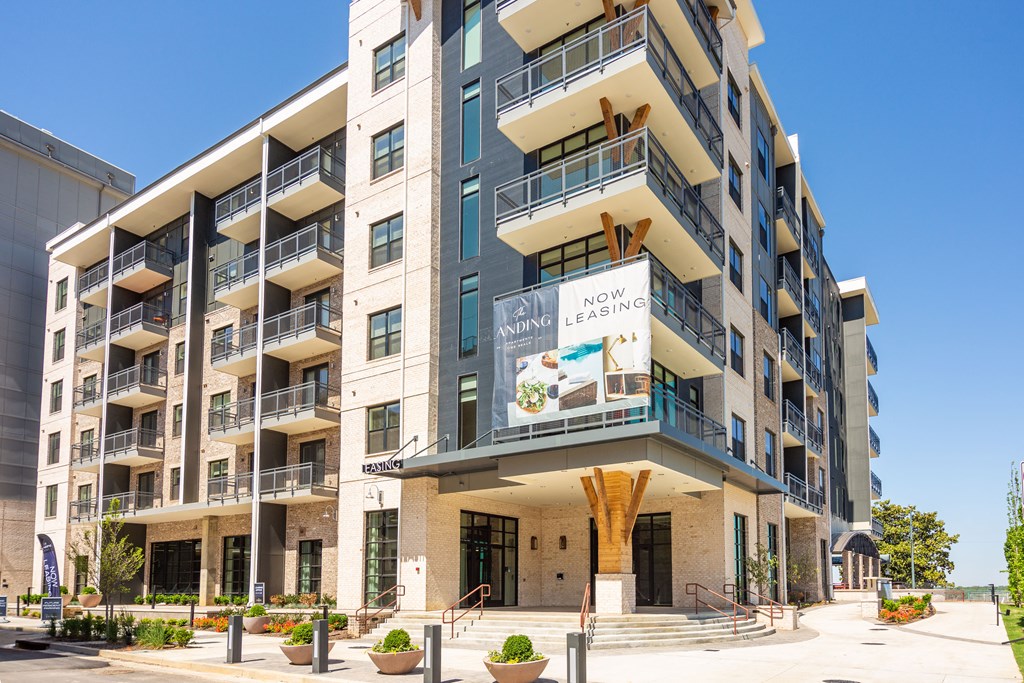 a large apartment building with balconies and a large sign on the side of it