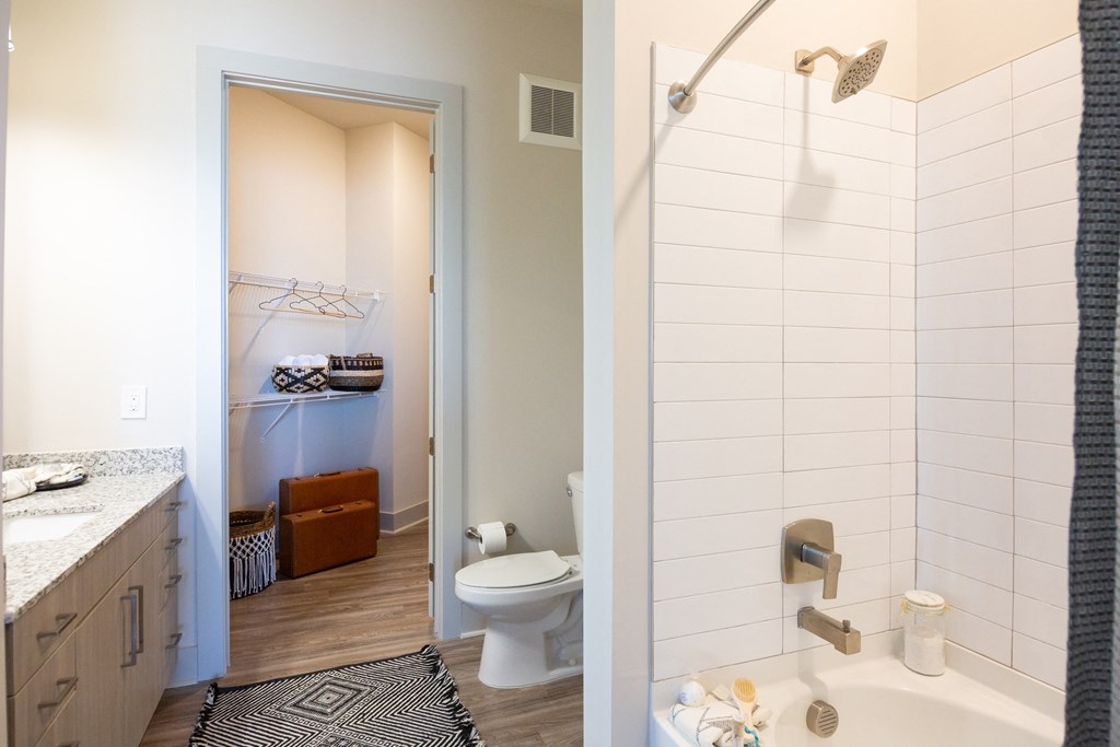 a bathroom with a shower and a toilet and a sink