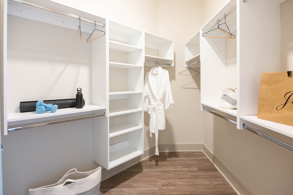 Luxury Apartments in Downtown Memphis, TN - The Landing - Spacious Closet with Hardwood Flooring, Shelves, and Hanging Racks.