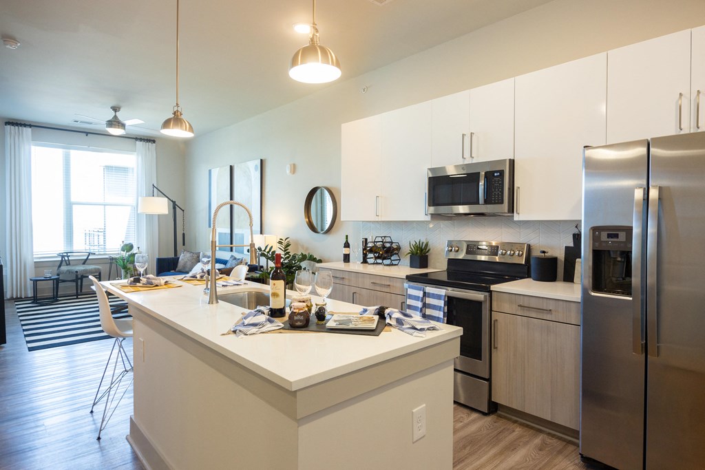 a kitchen with stainless steel appliances and a white counter top