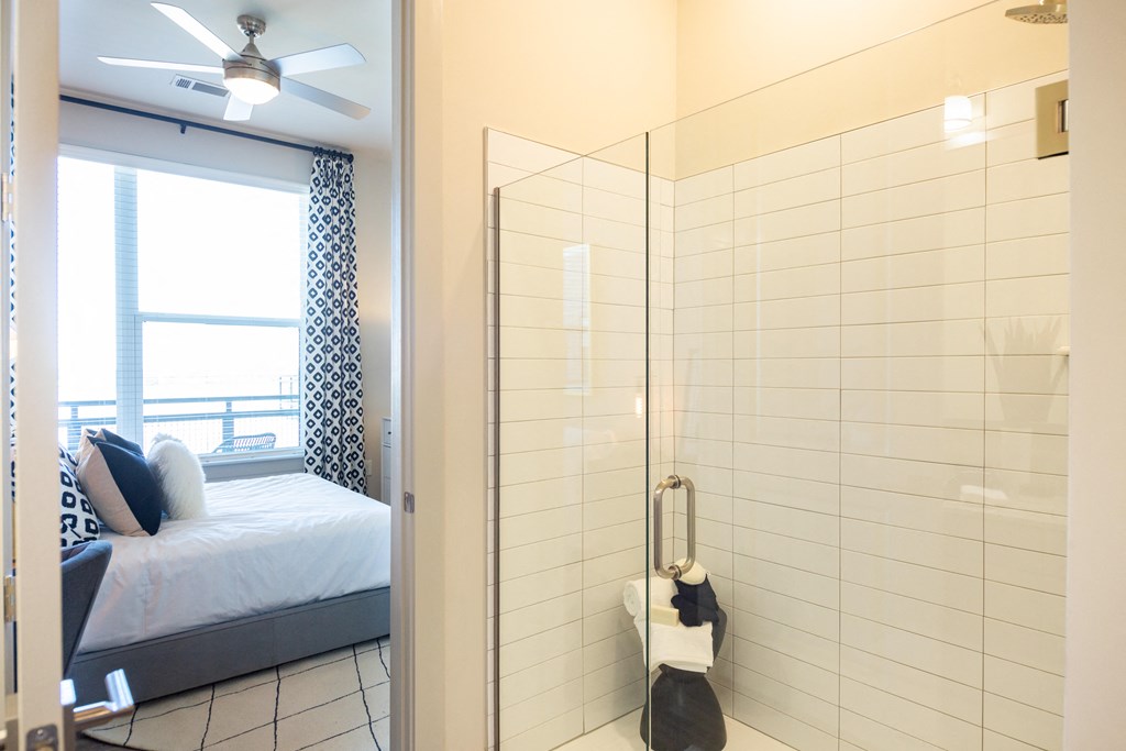 a room with a mirror and a bed and a window