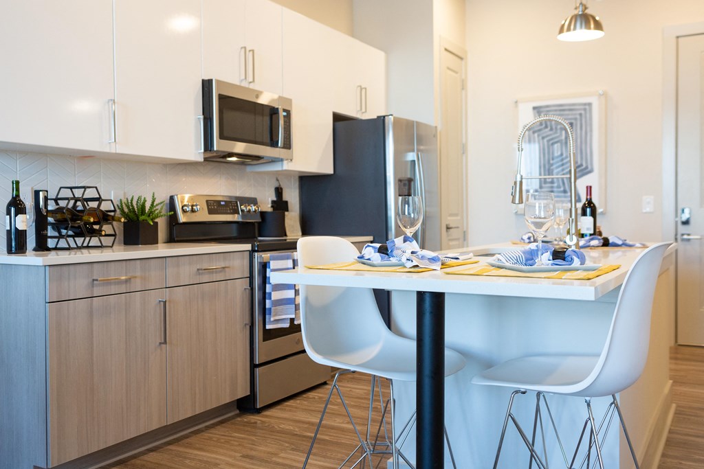 a kitchen and dining area with a table and chairs