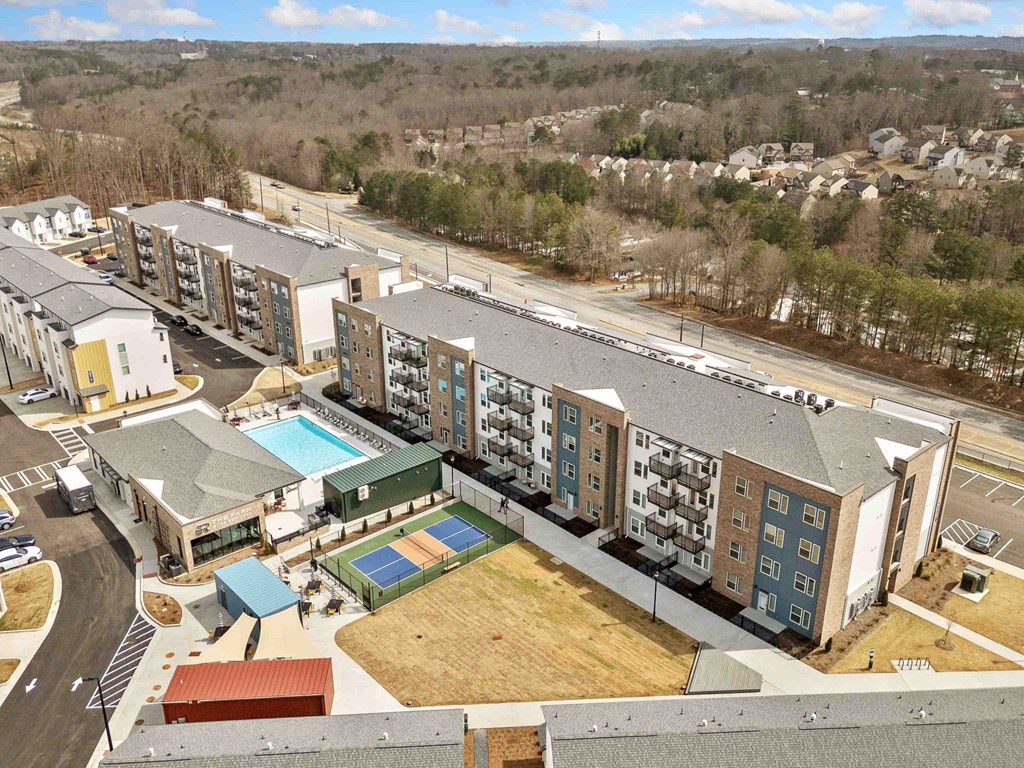 A large apartment complex with a pool and a playground.