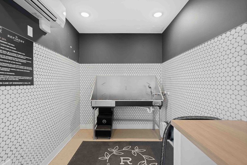 A black and white kitchen with a stove top oven.
