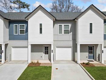 A two-story house with a grey and blue exterior.