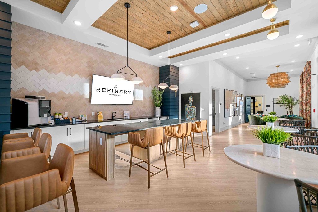 A modern kitchen with a dining table and chairs.