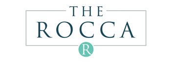 The image is a logo with the text "THE ROCCA" and a letter "R" in a circle.