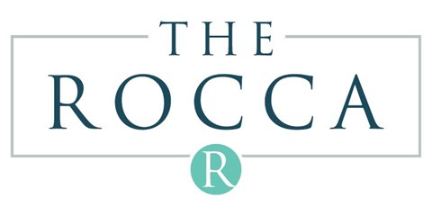 The image is a logo with the text "THE ROCCA" and a letter "R" in a circle.