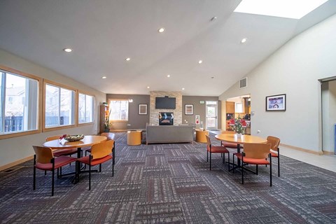 A conference room with a carpeted floor and a large table with chairs around it.