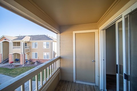 A balcony with a view of apartment buildings.
