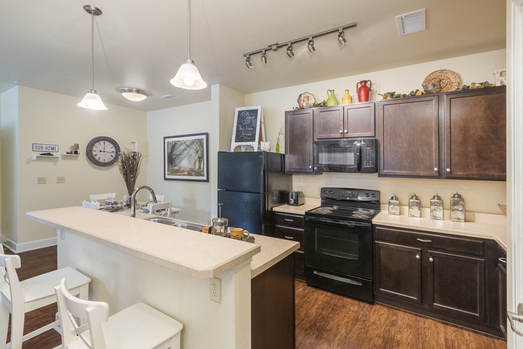 a kitchen with black appliances and a white counter top