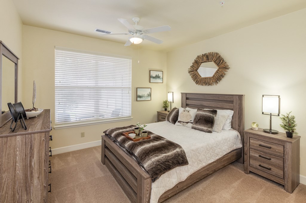 a bedroom with a bed and a ceiling fan