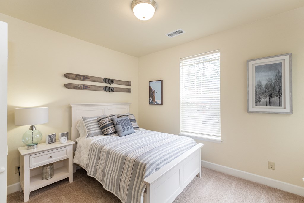 a bedroom with a bed and two surfboards on the wall