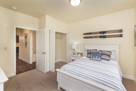 a bedroom with a bed and a closet and a bathroom