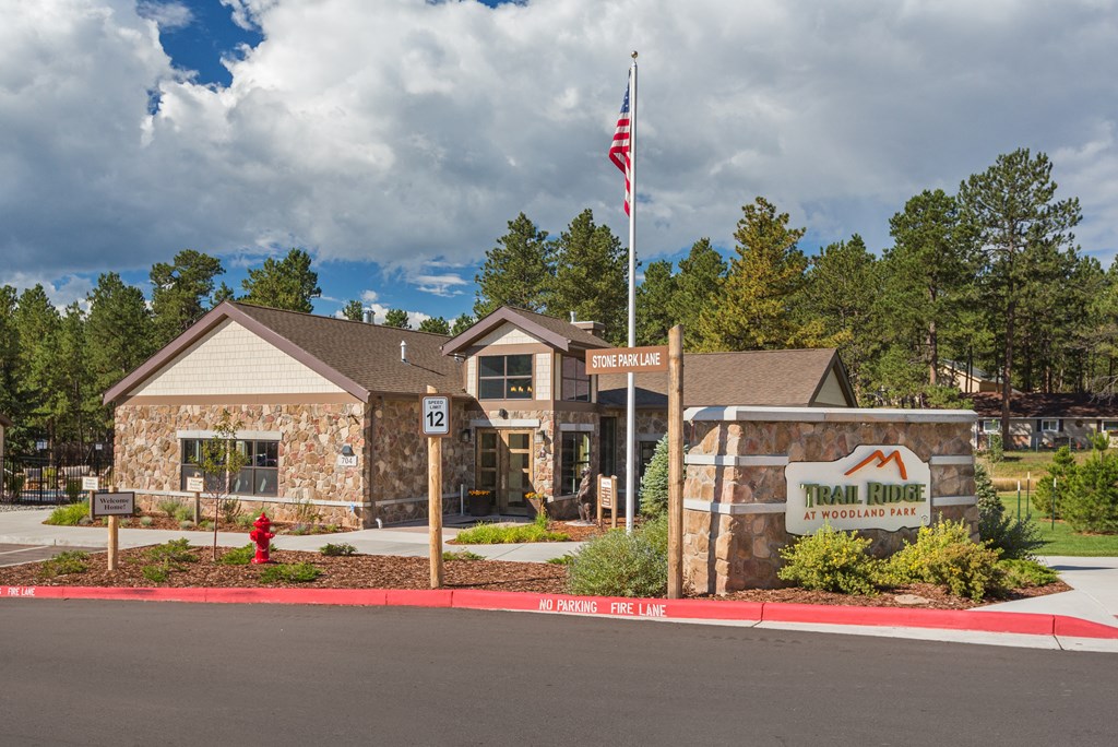 the front of a building with a sign and an flag
