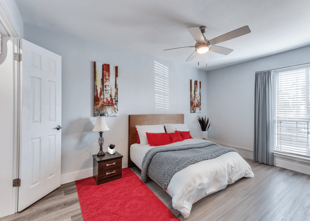 a bedroom with a bed and a ceiling fan