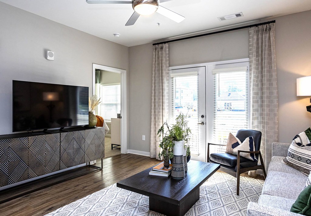 a living room with sliding glass doors and a tv