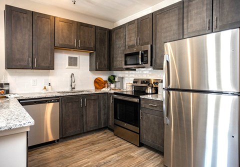 a kitchen with stainless steel appliances and wooden cabinets