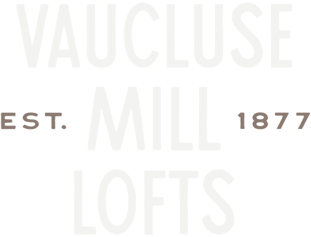 A green sign with white text that reads "VAUCLUSE MILL 1877 LOFTS".