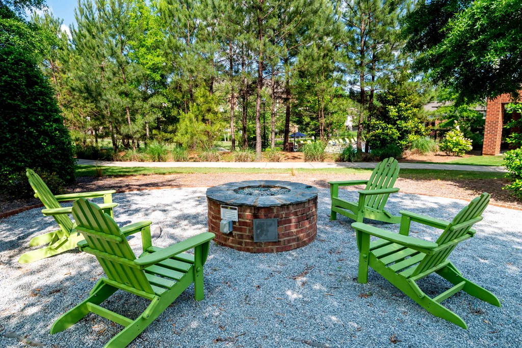 Luxury Apartments in Greenville, SC - Velo Verdae - Firepit with Adirondack Chairs and Surrounding Trees