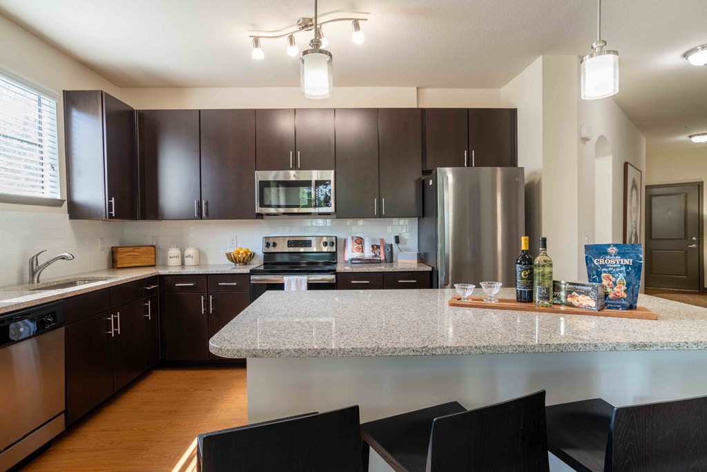 full kitchen with granite counter tops and stainless steel appliances