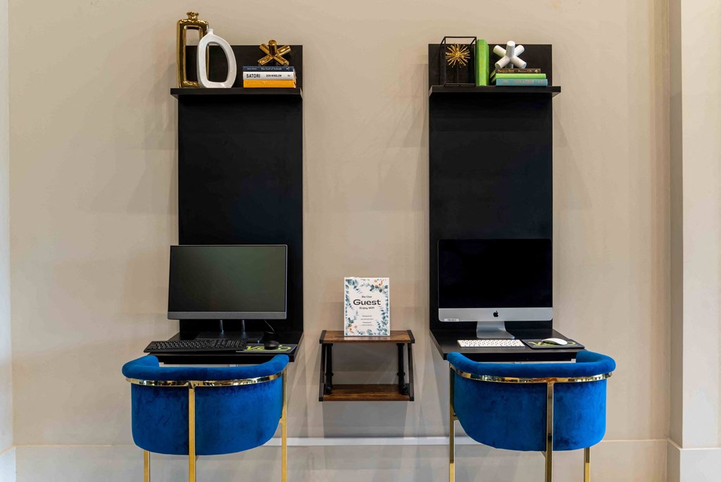 a room with two monitors and a computer on a table