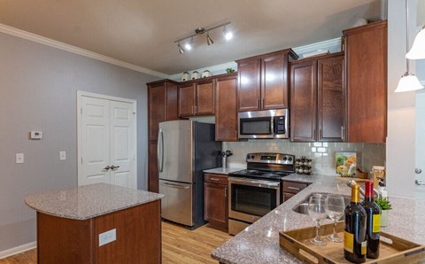 a kitchen with stainless steel appliances and granite counter tops