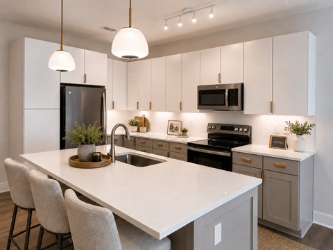 A modern kitchen with a white countertop and grey cabinets.