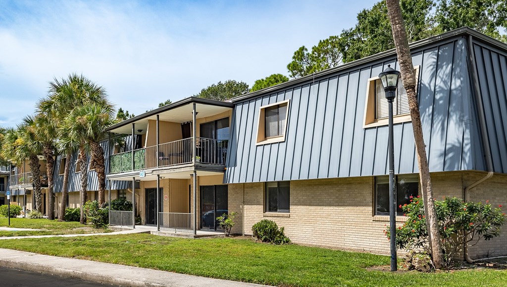 A modern two-story building with a balcony on the upper floor at Waterview at Rocky Point, Tampa, FL