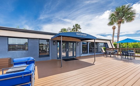 A wooden deck with a blue canopy and a pool table at Waterview at Rocky Point, Tampa, FL