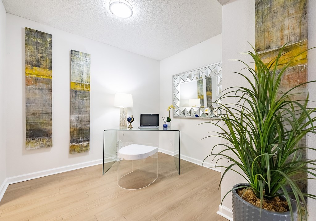 A room with a glass table, a mirror, and a potted plant at Waterview at Rocky Point, Tampa, FL