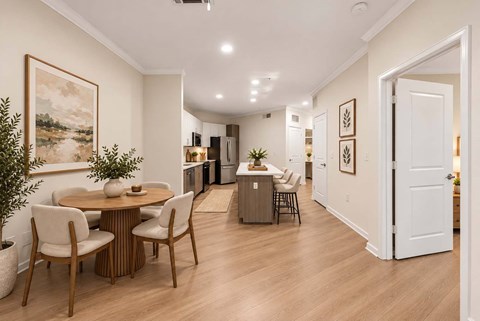 A dining room with a table and chairs.