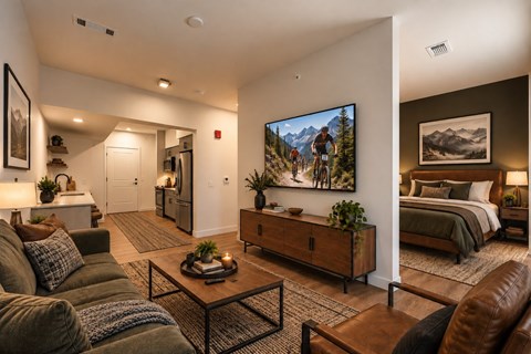 A living room with a couch, a coffee table, and a large painting of a mountain scene on the wall.