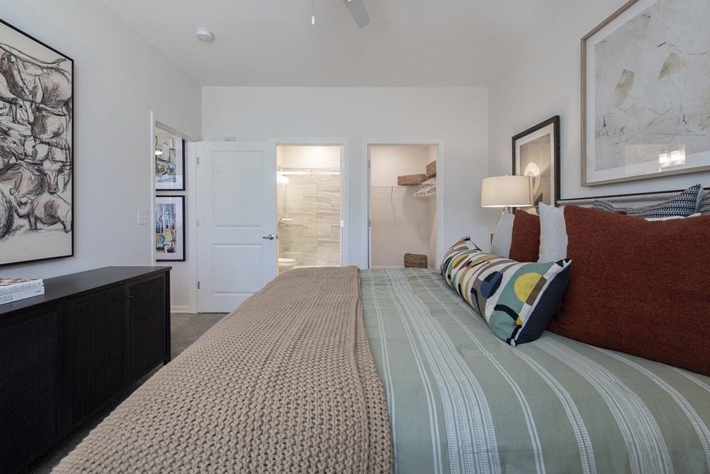 a bedroom with a bed and a bathroom with a shower