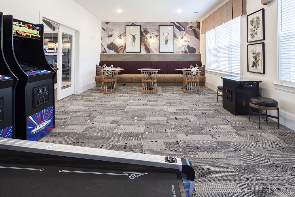 a room with a pool table and a video game
