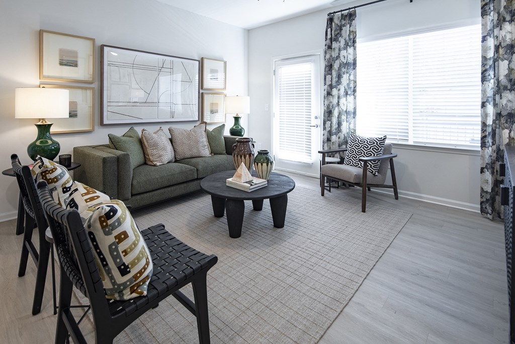 a living room with a couch and chairs and a table