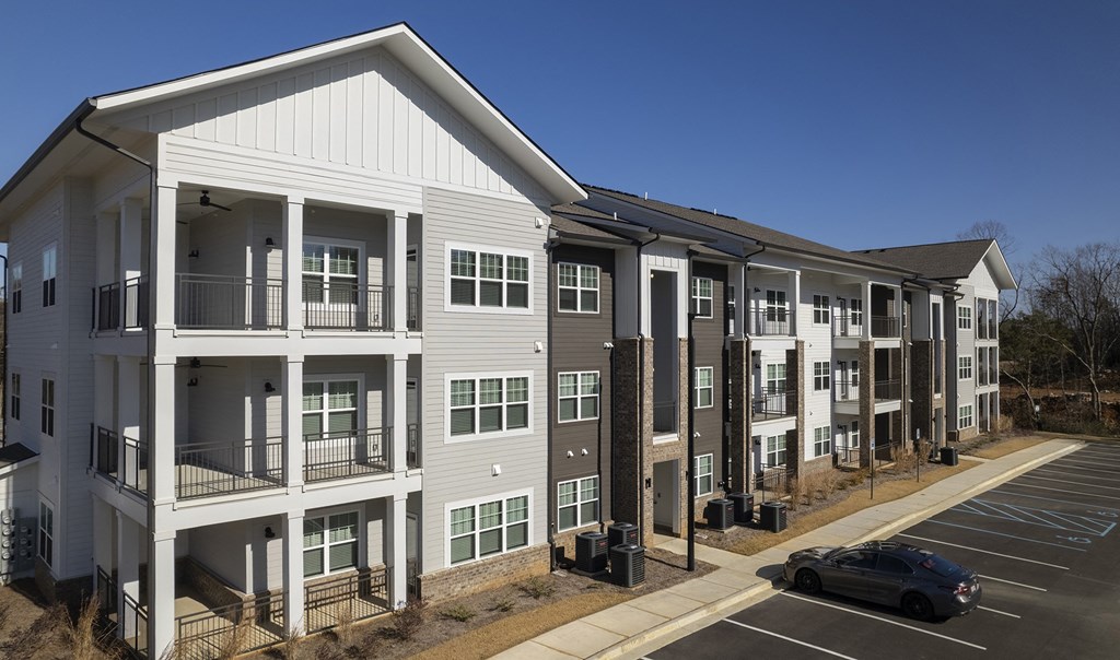 an apartment building with a car parked in front of it