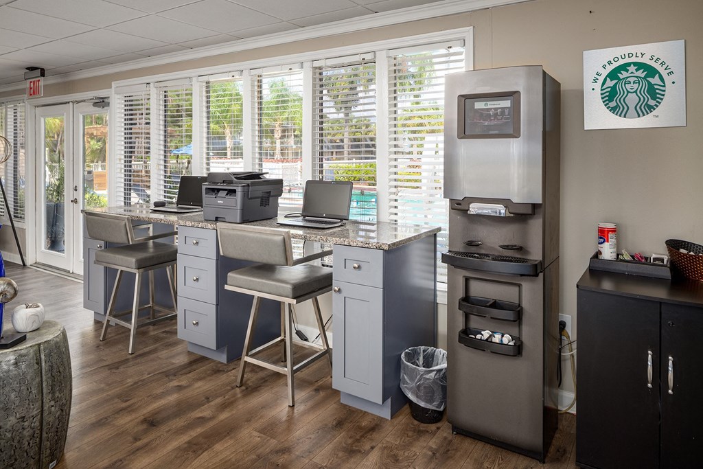 a break room with computers and stools in front of a wall of windows  at Waterview at Rocky Point, Florida, 33634