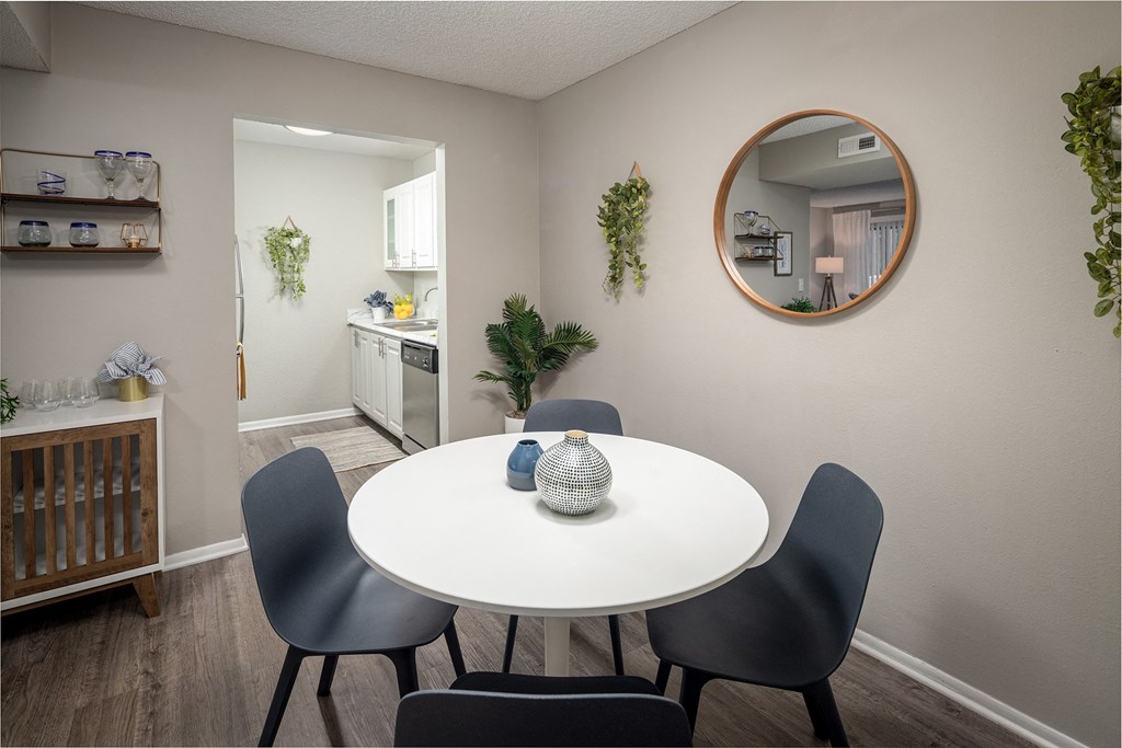 a dining area with a table and chairs and a kitchen in the background  at Waterview at Rocky Point, Florida