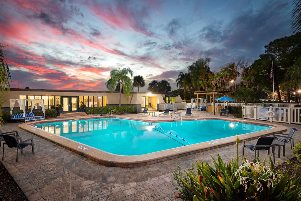 a resort style pool with lounge chairs and umbrellas at dusk  at Waterview at Rocky Point, Florida, 33634
