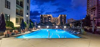 a swimming pool with a city skyline in the background
