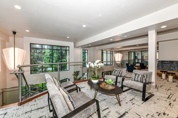 a living room filled with furniture and a large window