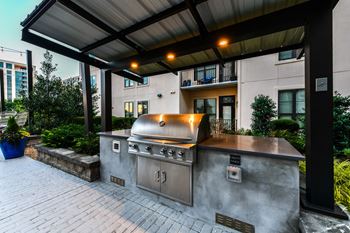 an outdoor kitchen with a stainless steel barbecue