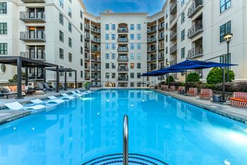 a swimming pool in front of an apartment building