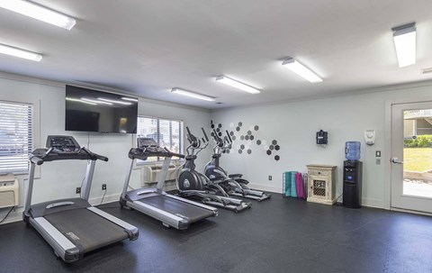 A spacious room with treadmills and elliptical machines.