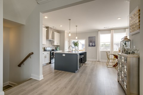 A kitchen with a dining table and chairs.